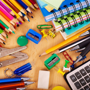 Assortment of school supplies pencils, pencil sharpener, calculator